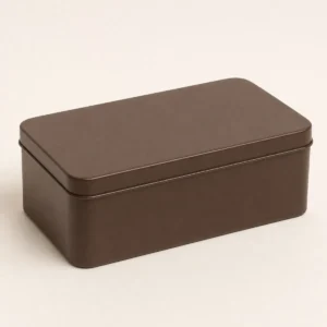 Unbranded chocolate cocoa tin box on a warm gray studio background