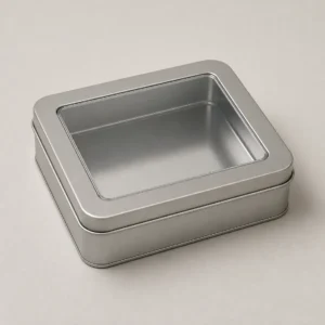 Unbranded clear window tin box on a warm gray studio background