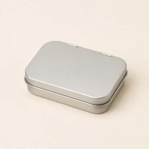 Unbranded discover mint tin box packaging on a warm gray studio background