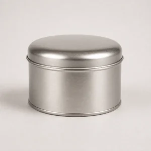 Unbranded dome lid round tin on a warm gray studio background