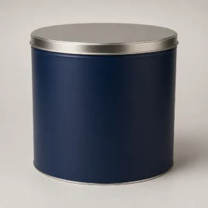 Unbranded large popcorn tin container on a warm gray studio background