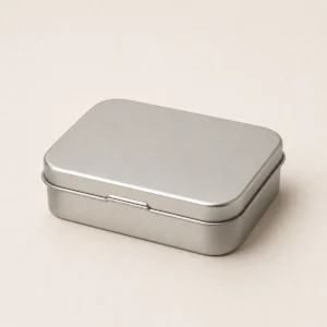Unbranded pop lid mint tin on a warm gray studio background