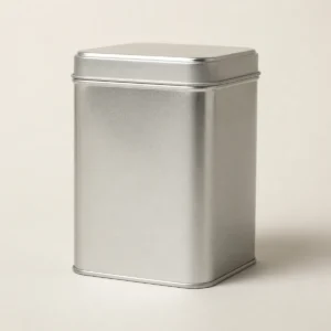 Unbranded premium square tea tin on a warm gray studio background