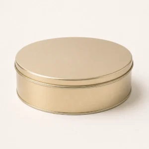 Unbranded premium tin cookie box on a warm gray studio background