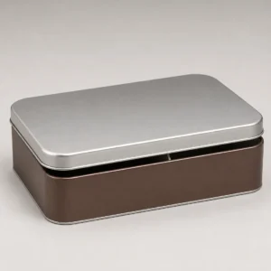 Unbranded rectangle chocolate tin on a warm gray studio background