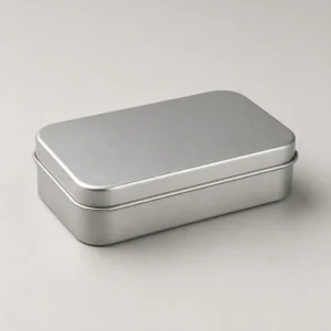 Unbranded small rectangle tin on a warm gray studio background